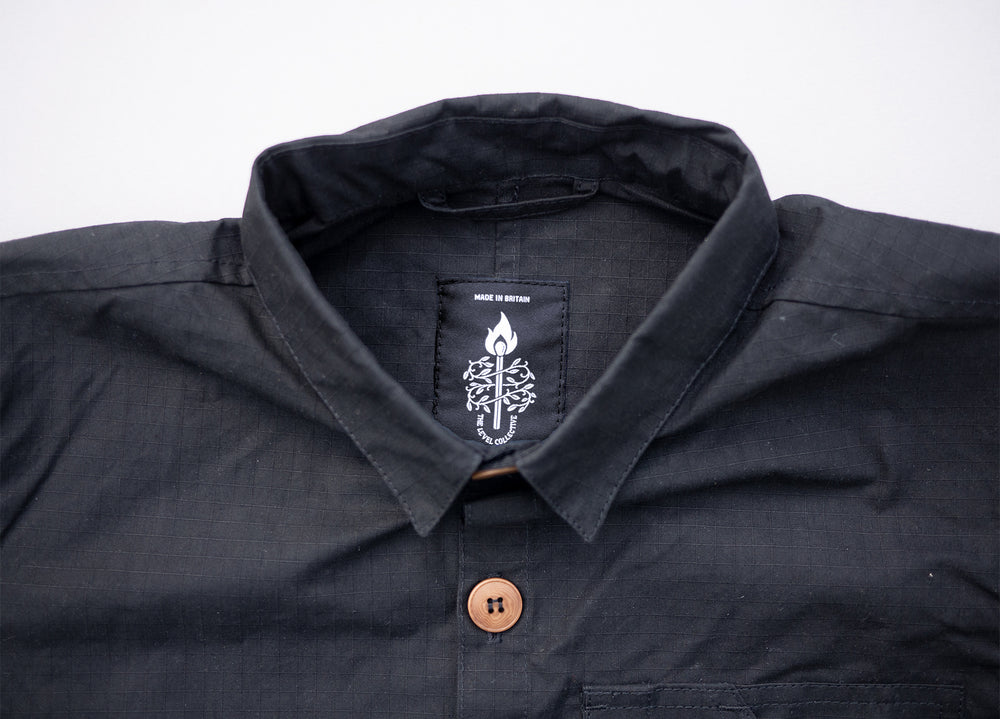 Black Unisex Overshirt handmade in Britain from weatherproof waxed organic cotton and sustainably sourced natural corozo nut buttons.