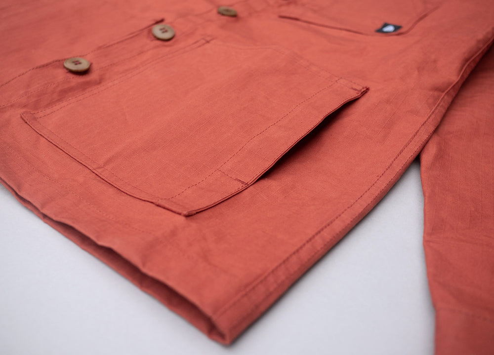 Rust coloured Unisex Overshirt handmade in Britain from weatherproof waxed organic cotton and sustainably sourced natural corozo nut buttons.