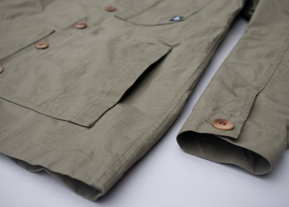 Olive coloured Unisex Overshirt handmade in Britain from weatherproof waxed organic cotton and sustainably sourced natural corozo nut buttons.