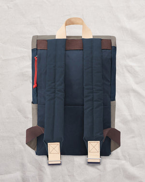 Back of the Navy & Stone roll top backpack with padded shoulder straps and natural leather tabs