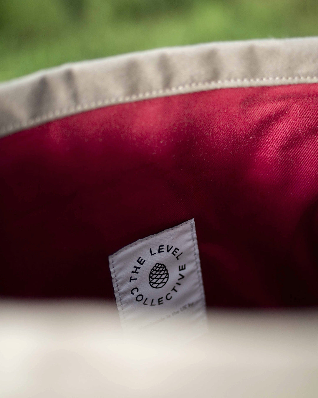 Crimson cotton twill lining and woven maker's label inside the stone roll top