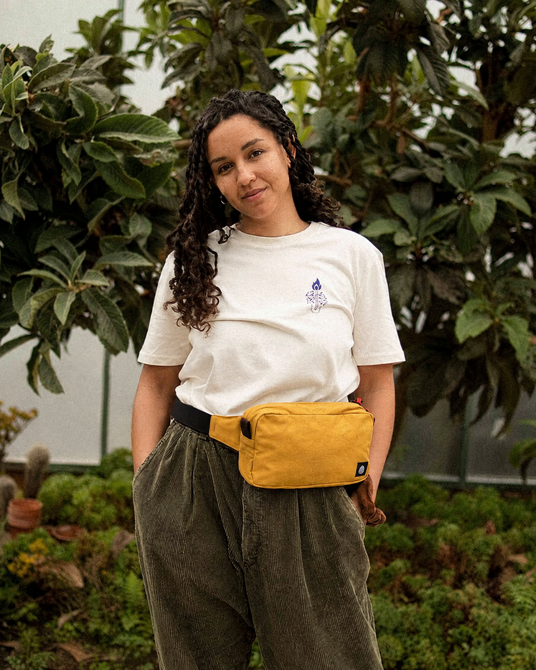 The Scout in Mustard waxed cotton worn as a waist bag with black cotton webbing strap