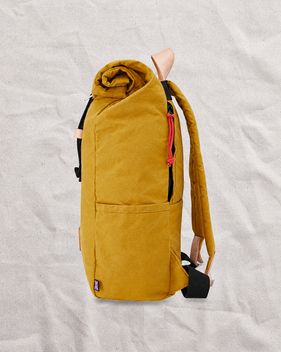 Side profile of the Mustard roll top backpack, a waxed canvas backpack for city and outdoor days