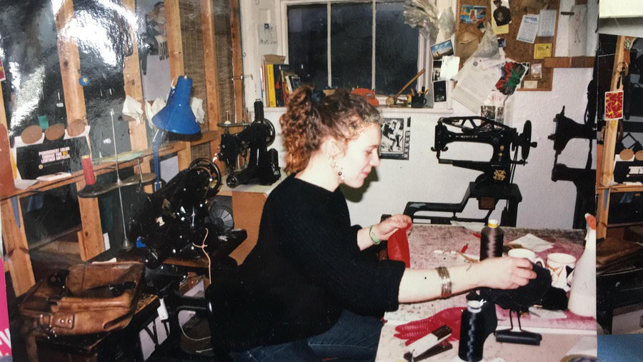 Master maker Lesley at her desk, stitching a waxed cotton backpack together