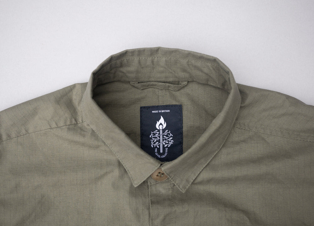 Olive coloured Unisex Overshirt handmade in Britain from weatherproof waxed organic cotton and sustainably sourced natural corozo nut buttons.