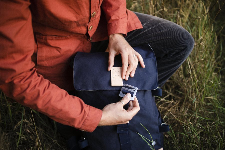 Hand-finished closure on a Logan backpack in Navy